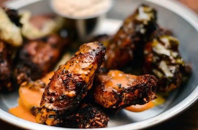 NSYC house-smoked wings tossed in house sauces — Guy Fieri pick